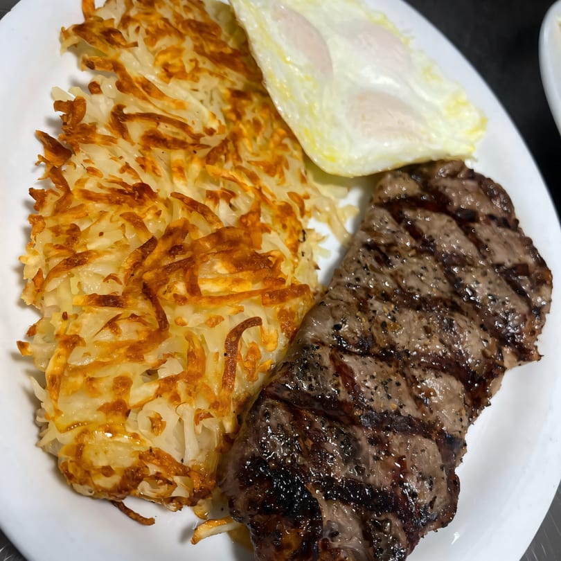 Jerry's Cafe's steak and eggs breakfast with crispy hash browns and two fried eggs.